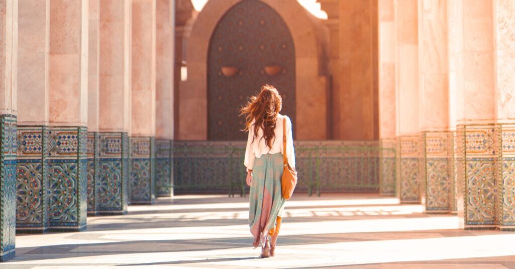 Girl walking in the yard of Moulay Hassan II mosque